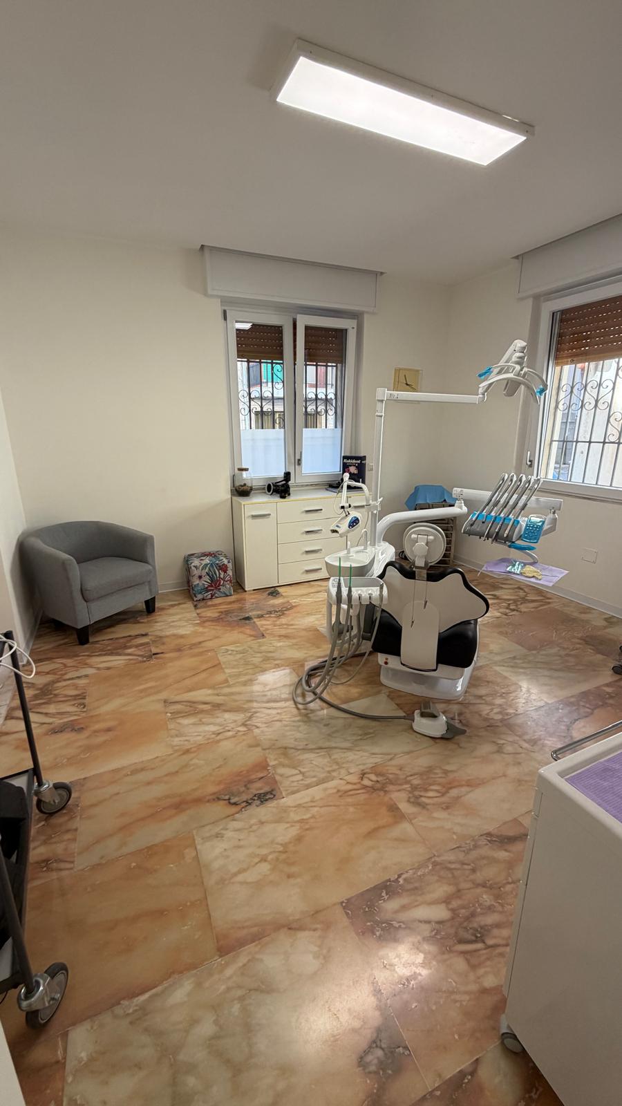 Una sala operativa con poltrona e attrezzatura odontoiatrica